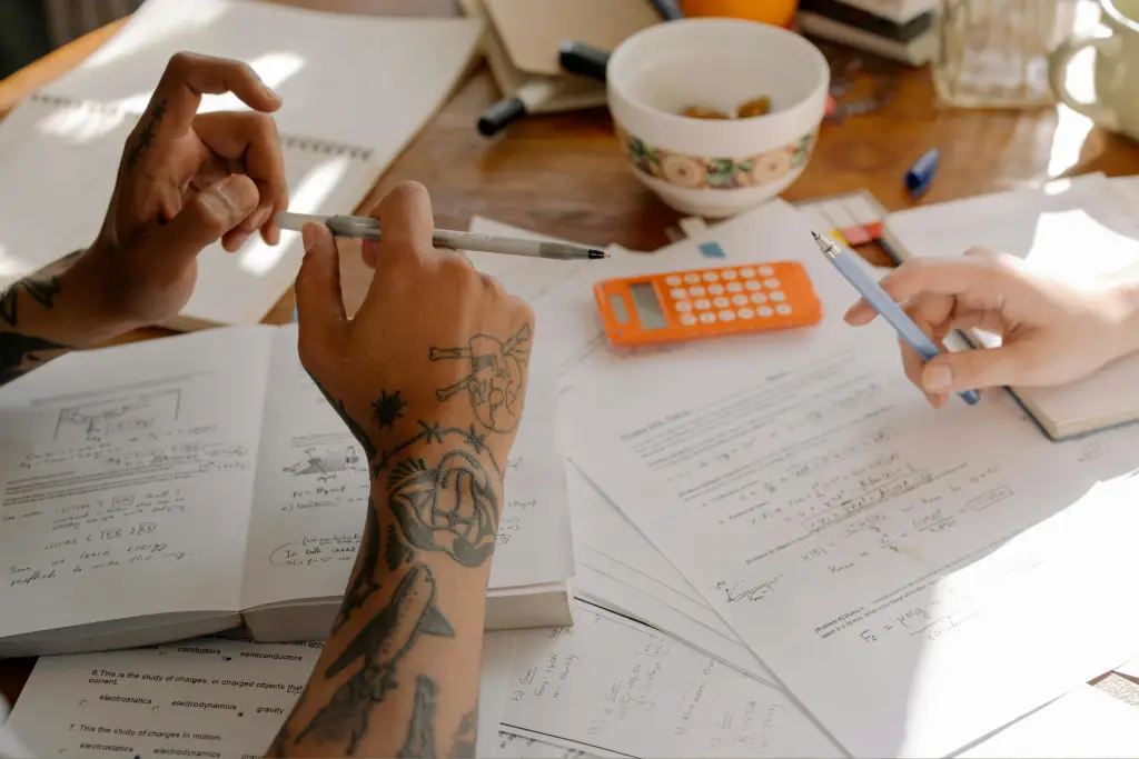 Hands studying with books and calculator. Hands studying with books and calculator.