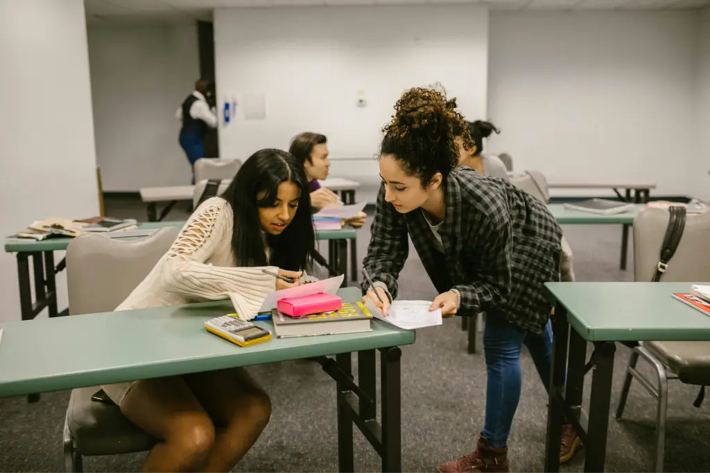 Students collaborating in a classroom setting. Students collaborating in a classroom setting.