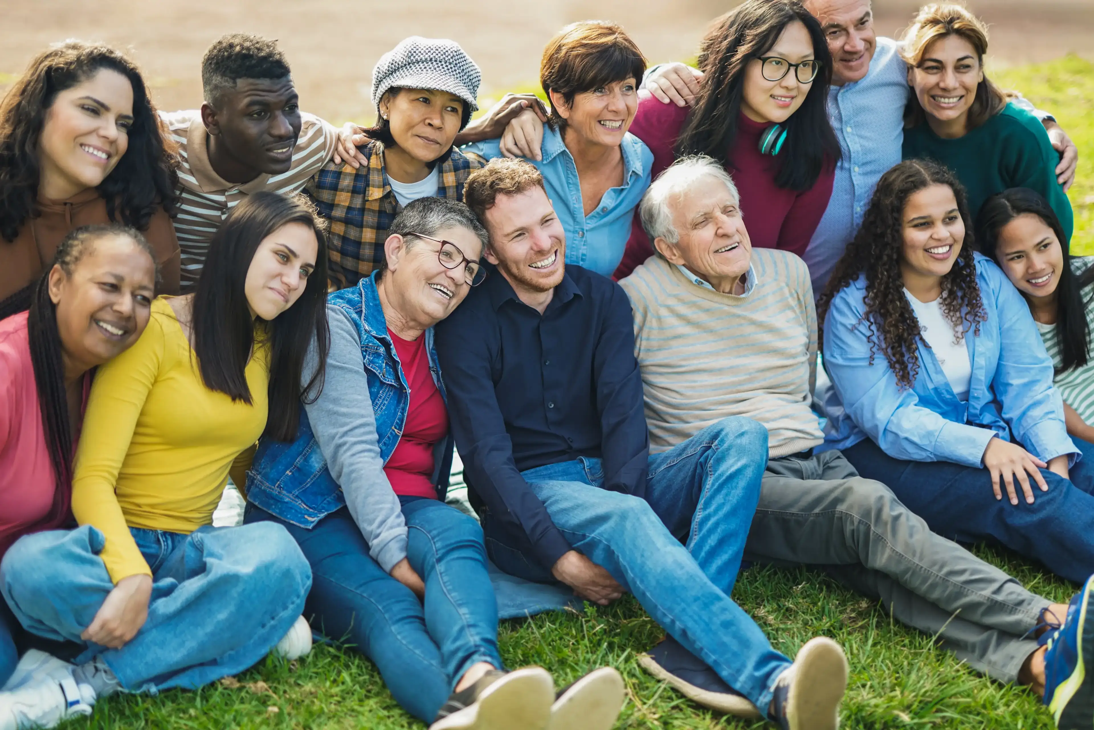 Diverse group of people sitting together outdoors. Diverse group of people sitting together outdoors.