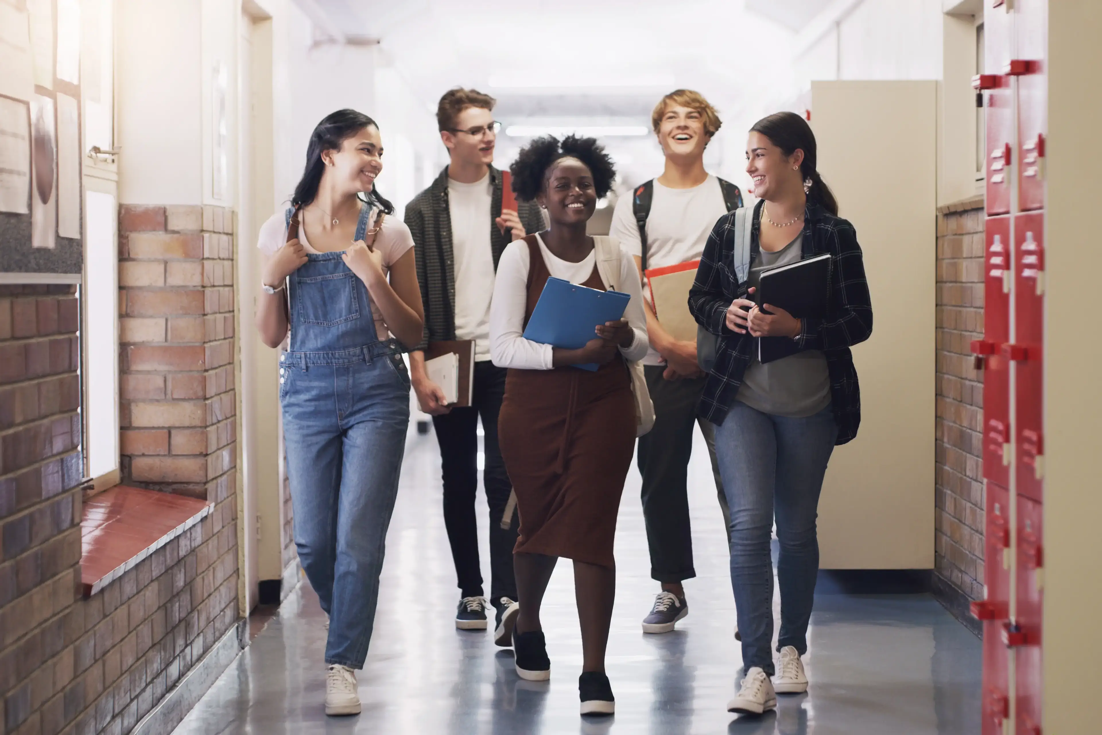 Students walking together in a school hallway. Students walking together in a school hallway.